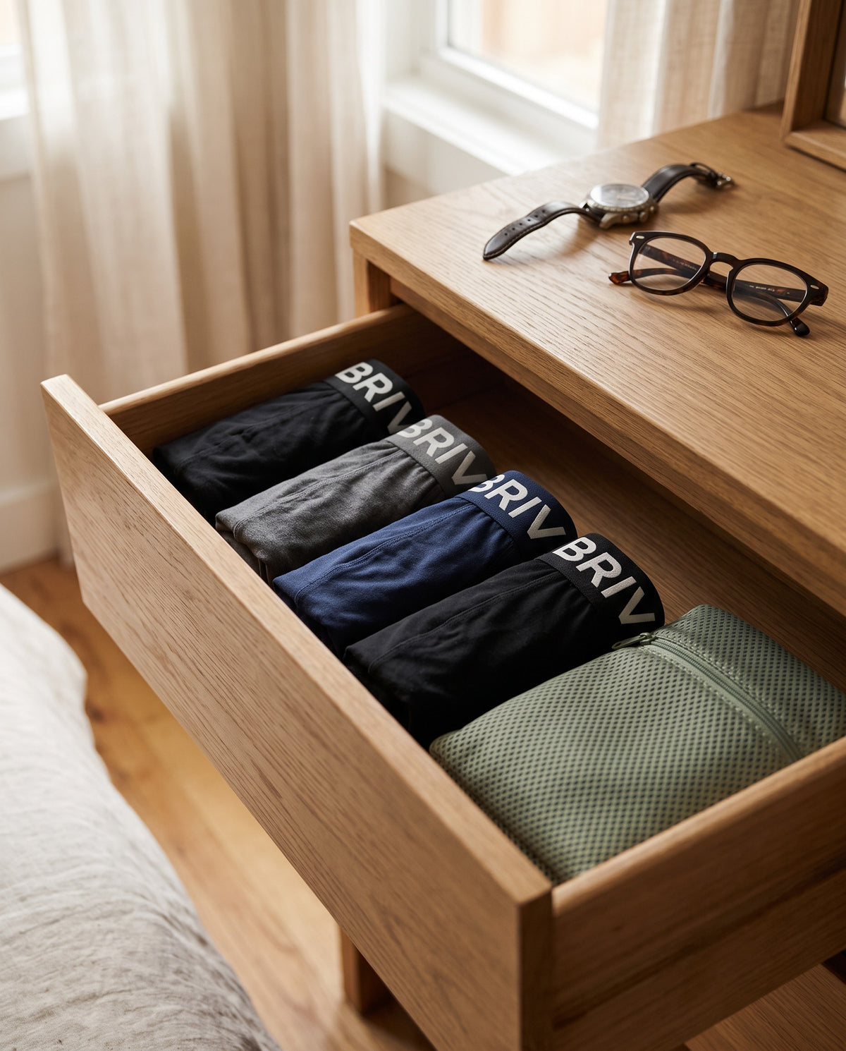 Four folded pairs of BRIV boxer briefs in a dresser drawer